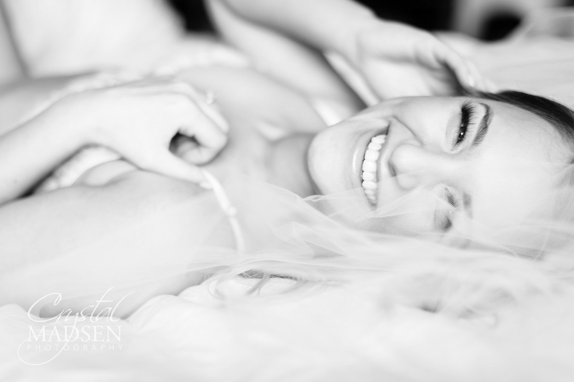 black and white boudoir photo of a laughing bride