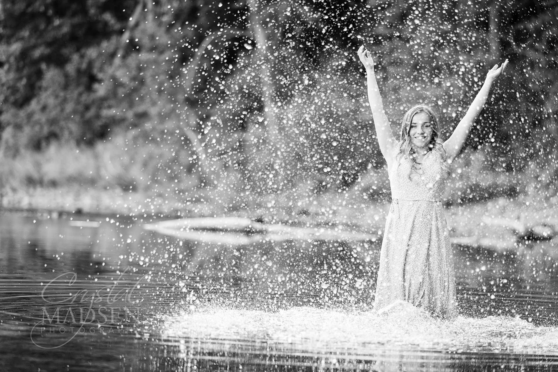 high school girl splashing water in black and white